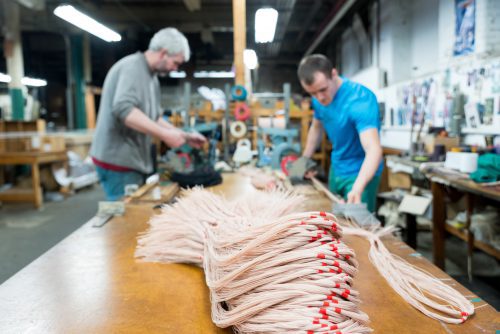 Employees at Maine Thread Company in Lewiston cut and bundle the company’s signature waxed tapered handsewing threads.