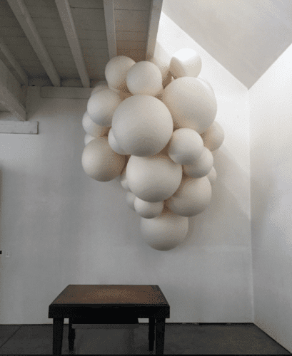 Sarah Bouchard, Potent, 2015, site-specific installation of 50 handmade paper orbs, dimensions variable