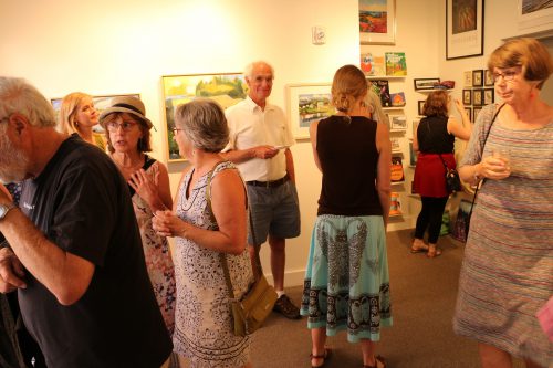 visitors at Maine Farmland Trust Gallery at the July art walk; photo by Tony Chiodo for BCC